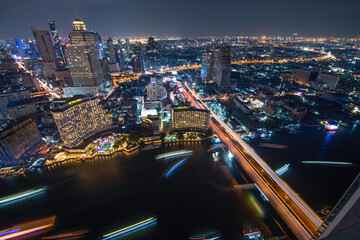 Bangkok night cityscape with high building and famous hotel beside Chao phra ya river,Bangkok,Thailand.