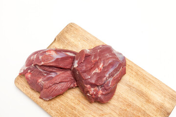 Fresh raw lamb meat on wooden cutting board, close-up, top view, copy space. Dieting product