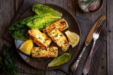 Cooked fish fillet with lemon and vegetables