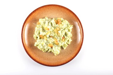 Tasty Slovak potato dumplings halusky with steamed sauerkraut closeup in the plate on the table.