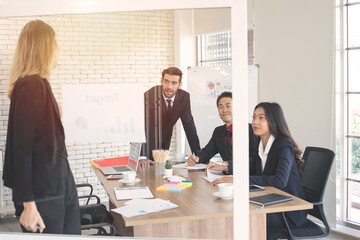 Caucasian business woman giving graph presentation chart in business seminar with multi ethnic coworker at work place.