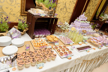 Delicious sweets on a rustic sweet table at the wedding party