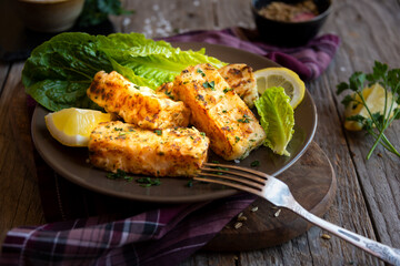 Cooked fish fillet with lemon and vegetables