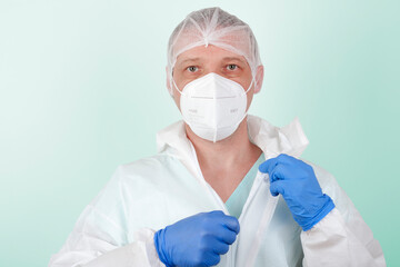 Male nurse with  face mask ffp2 take off  protective coverall clothing