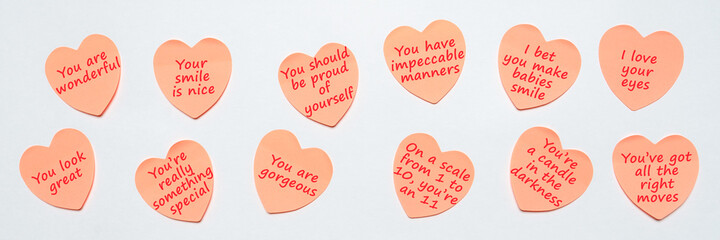 Happy World or National Compliment Day. Pink paper stickers in heart shape with text of popular...
