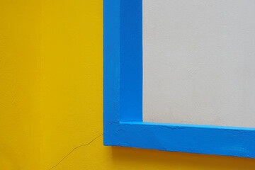 Background of bright colored the wall painted with colors yellow cut with lines blue and wall white , Ideal for use in the design fairly.