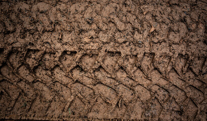 Tyre track on dirt sand or mud, Picture in retro or grunge tone. Car drive on sand. off road track. Track on grass field. Track in farm.