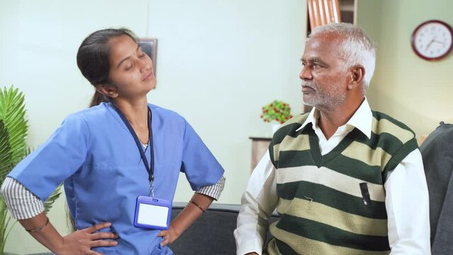 Doctor or physician nurse helping senior man for neck exercise by rotating patients head at home - concept of elderly people home health care or service