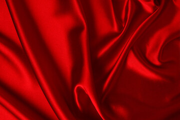 Red silk or satin luxury fabric texture can use as abstract background. Top view.