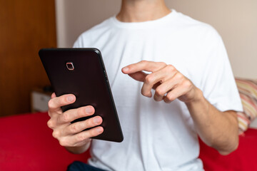 Unrecognizable male person using a black tablet