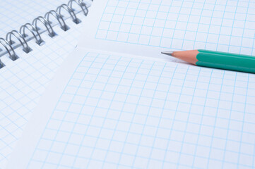 pencil lies on an open notebook. close-up.