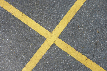 Old yellow lines on a cement floor in the parking lot , which ideal for use in the background design  put images and insert text