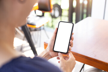 cell phone blank white screen mockup.woman hand holding texting using mobile on desk at office.background empty space for advertise.work people contact marketing business,technology