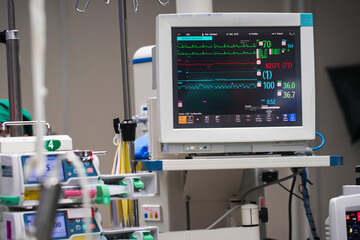 Vital signs monitor with machines during surgery on a patient in operating room.