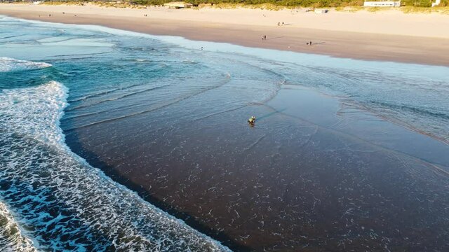 Fisherman battling the Waves during Sunset at Costa da Caparica beach, Portugal