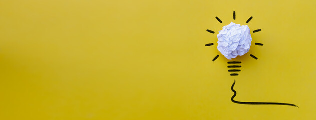 Great creative idea concept with crumpled white paper light bulb isolated on yellow banner background © flyalone