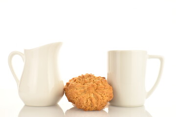 Several delicious torchetti cookies with oatmeal and white ceramic dishes, close-up, isolated on white.