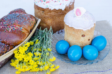 Easter eggs with Easter, flowers and a wicker basket. Religious holidays concept