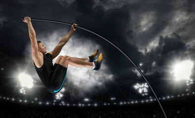 Professional pole vaulter training at the stadium in the evening