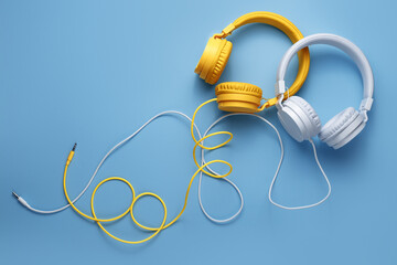Two stylish headphones over blue background. Music concept.