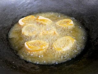 Squid cut into small pieces and fried with flour. The flour has been mixed with eggs to add flavour and to make it crisper.