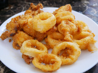 Squid cut into small pieces and fried with flour. The flour has been mixed with eggs to add flavour and to make it crisper.