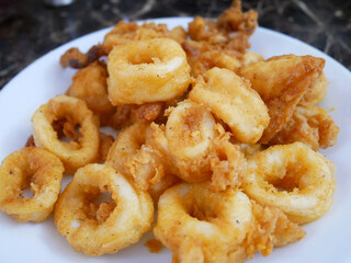 Squid cut into small pieces and fried with flour. The flour has been mixed with eggs to add flavour and to make it crisper.