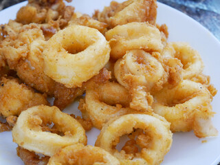 Squid cut into small pieces and fried with flour. The flour has been mixed with eggs to add flavour and to make it crisper.