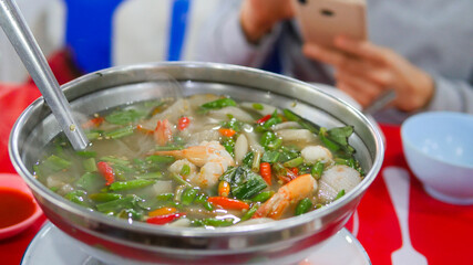 Clear soup Tom Yum Kung. Famous food of Thailand. It is sour, spicy, mellow and delicious. Ingredients: fresh shrimp, various types of mushrooms, kaffir lime leaves, fresh chili, galangal, lemongrass,