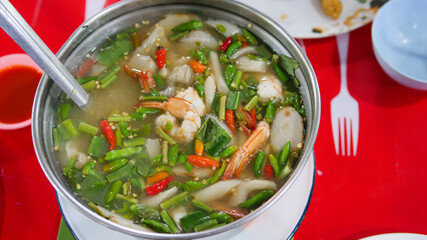 Clear soup Tom Yum Kung. Famous food of Thailand. It is sour, spicy, mellow and delicious. Ingredients: fresh shrimp, various types of mushrooms, kaffir lime leaves, fresh chili, galangal, lemongrass,
