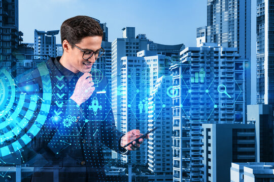 Eastern successful businessman trying to find new ideas using smartphone as a modern tool to solve problems at research and development department. Fintech hologram icons over Bangkok. - Powered by Adobe