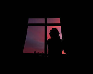 Woman silhouette in front of the window at sunset, Istanbul