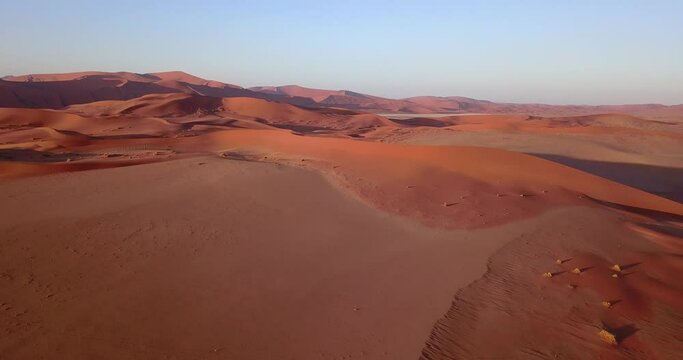 4K aerial drone footage of famous endless sand sea and Sossusvlei Namib Desert scenic red sand dunes on sunny morning in Namib-Naukluft Park in Namibia, southern Africa