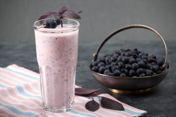 Fototapeta na wymiar Milkshake with blueberries and basil