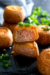 Meat pies isolated onblack board. Delicious mini pies.