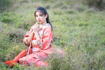 Beautiful Female wearing traditional japanese kimono with cherry blossom in spring, Japan.