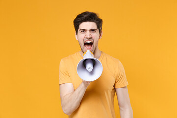 Young unshaved angry protestive agitating caucasian man 20s in casual basic t-shirt screaming...