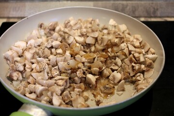 
Fried mushrooms champignons in a pan.