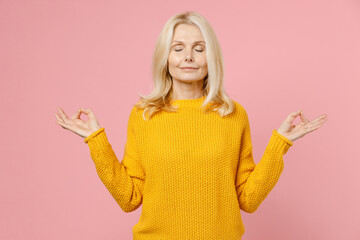 Smiling elderly gray-haired blonde woman lady 40s 50s years old in yellow sweater hold hands in...