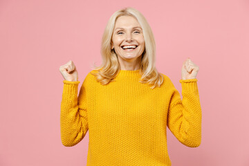 Happy joyful elderly gray-haired blonde woman lady 40s 50s years old in yellow casual sweater...