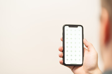 Businessman holding digital tablet in man hands, browsing internet or application with blank screen mock-up for your design at home office with blurry background with free space for custom text