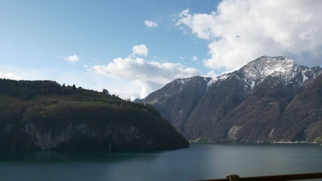 Mountain Lake Lucerne. Alps Switzerland Europe. View out of Car Moving on Highway Quay. Slow motion