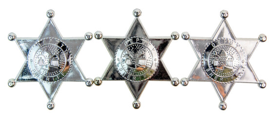 Three shiny toy plastic deputy sheriff badges