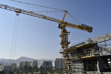 Fototapeta na wymiar Tower crane in a new civil construction site Building in Oman. Oman city. Muscat, Oman 