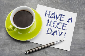 Green cup of coffee with  clean napkin and a metal ballpoint pen on grey background