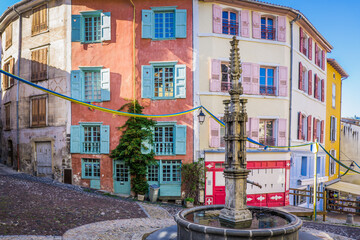Medieval street of the old town of le Puy en Velay (Auvergne, France) with colorful facades