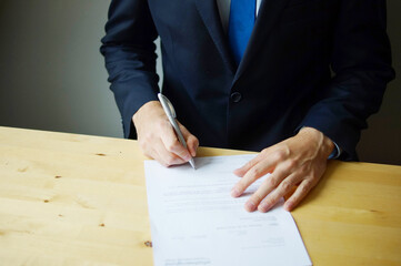 Businessman is signing a document