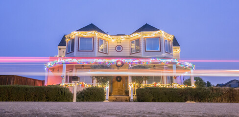 Suburban Home Adorned with Christmas Lights in the Evening