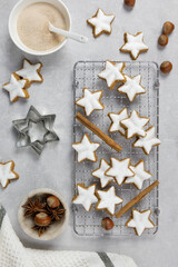 Christmas traditional German cookies, cinnamon stars with hazelnuts on a light concrete background. Top view.