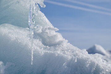 Fototapeta na wymiar Icicle, ice and snow on blue sky background.